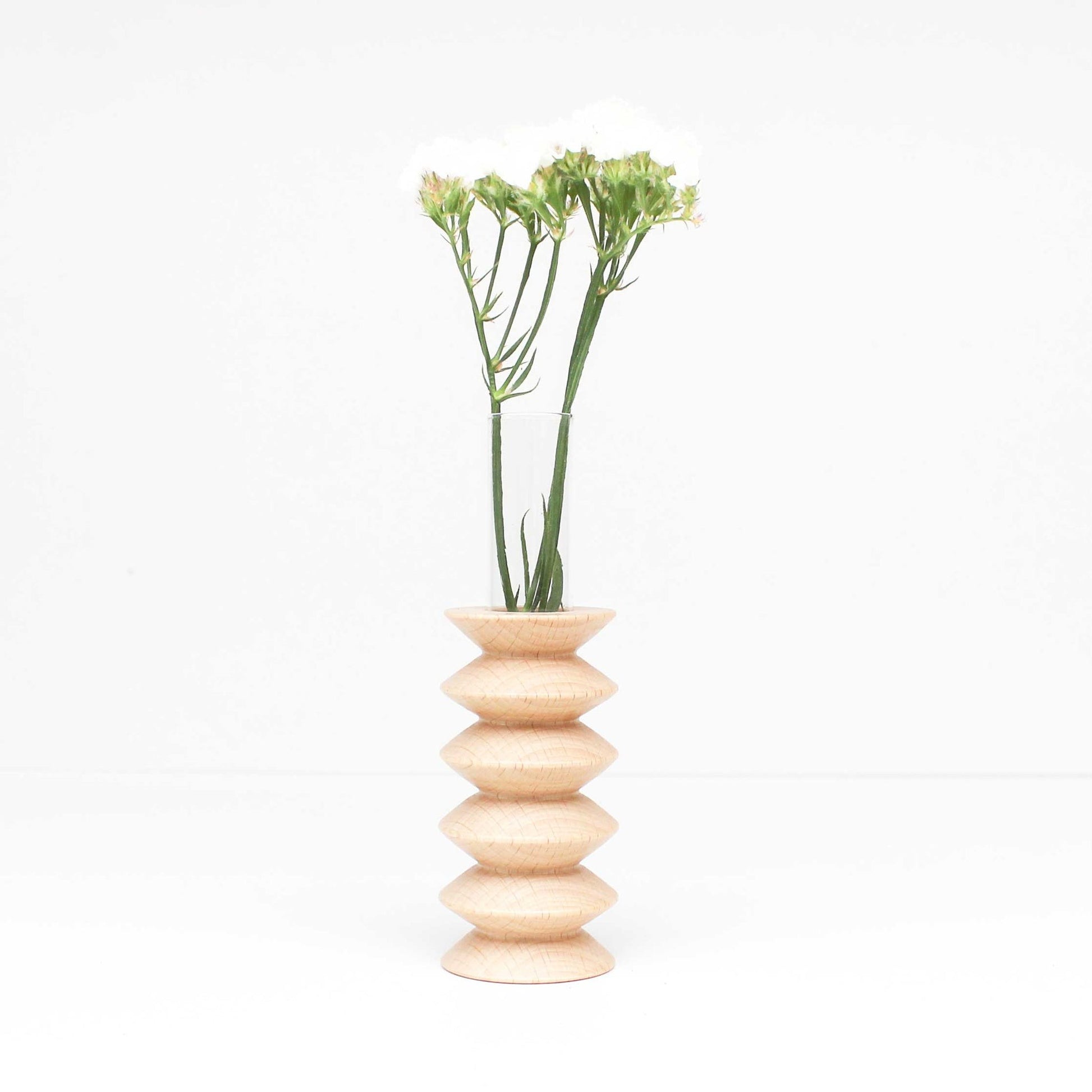 confident close-up of a solid beech wood totem vase with dramatic grain texture