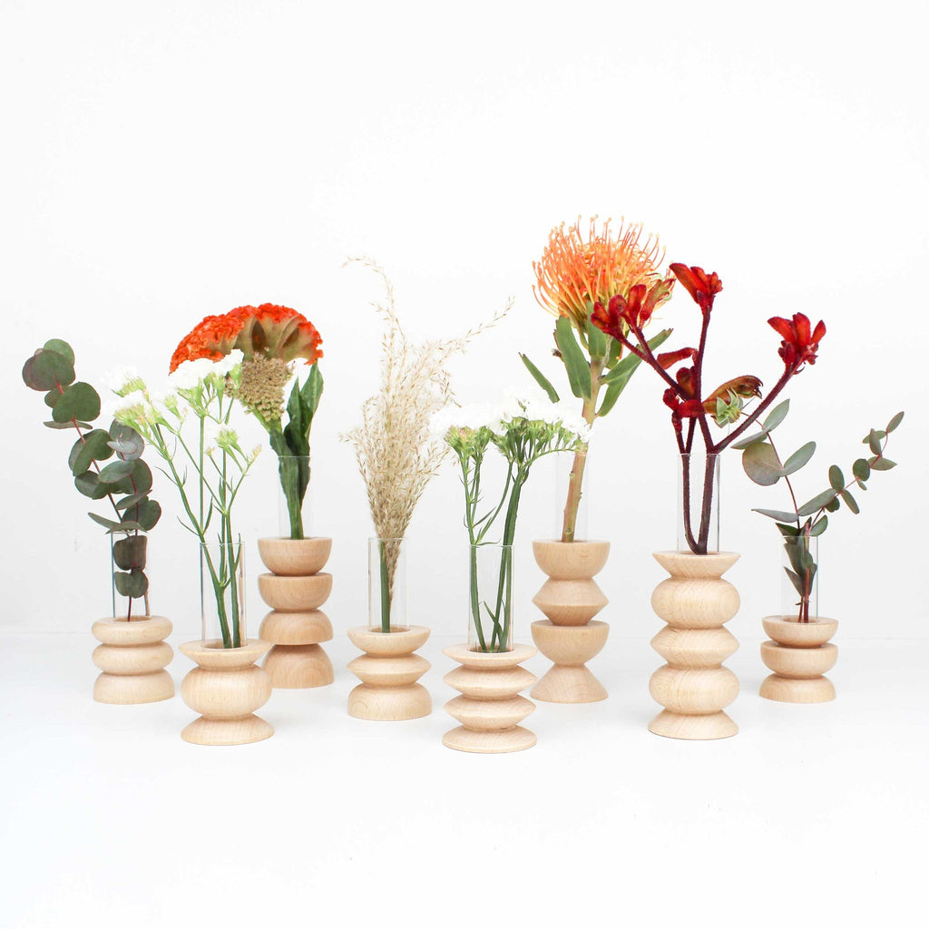 elegant beech wood totem vase with glass insert in soft morning light