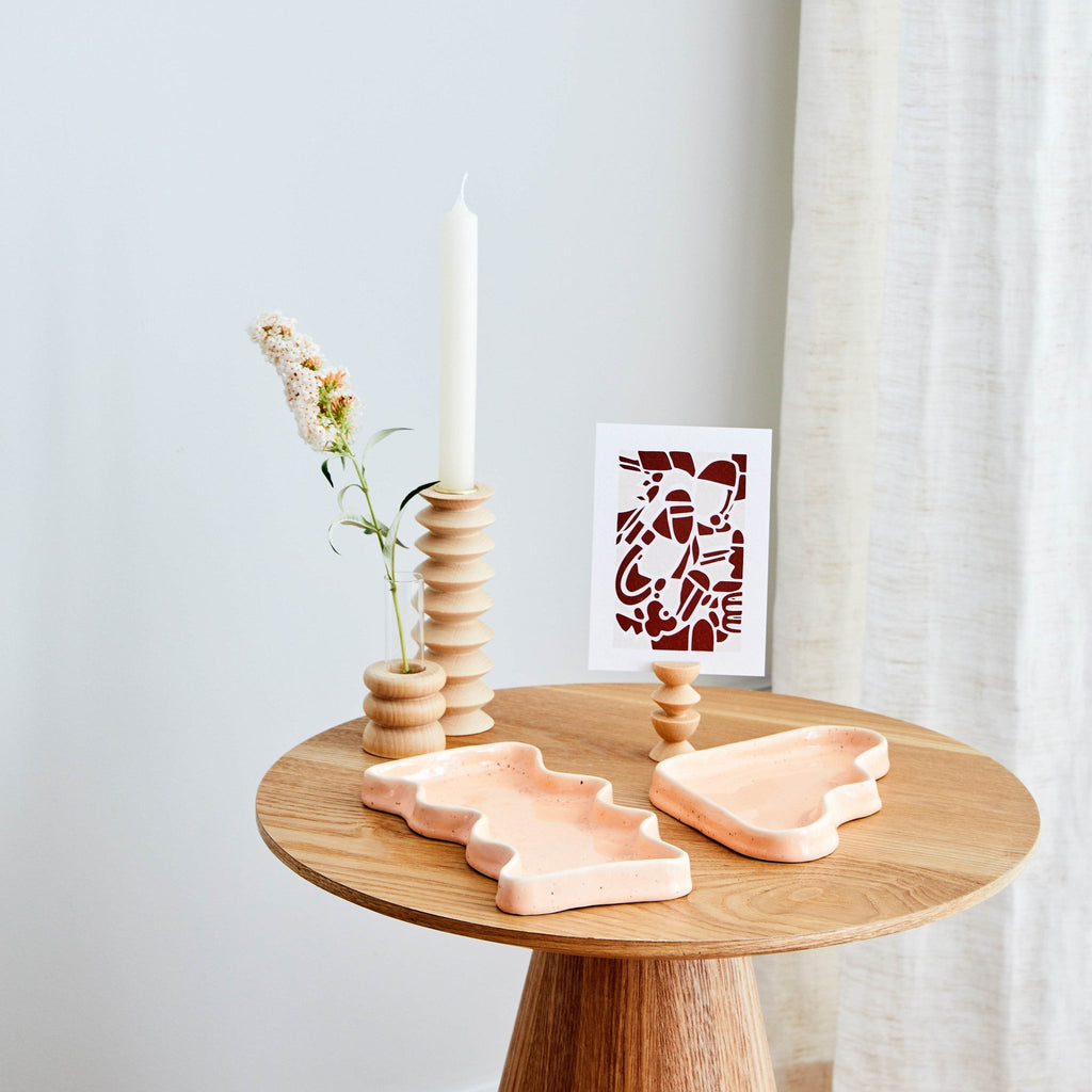 softly lit short totem wooden vase with a warm beech wood grain and a clear glass tube for flowers