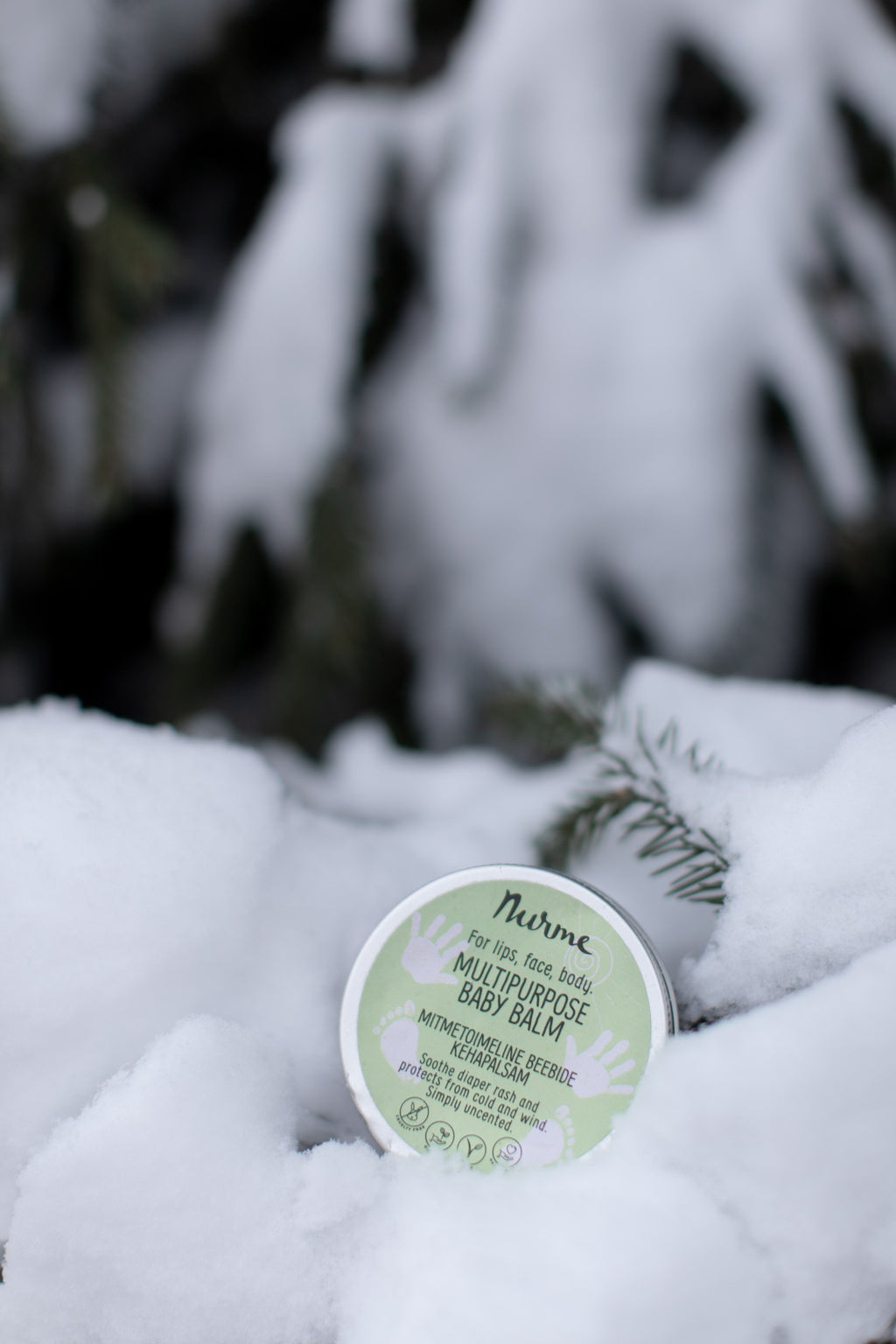 elegant close-up of organic baby balm jar with soft golden lighting