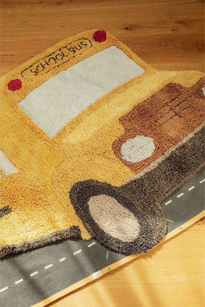 kids playing on a soft yellow school bus rug in a sunlit playroom