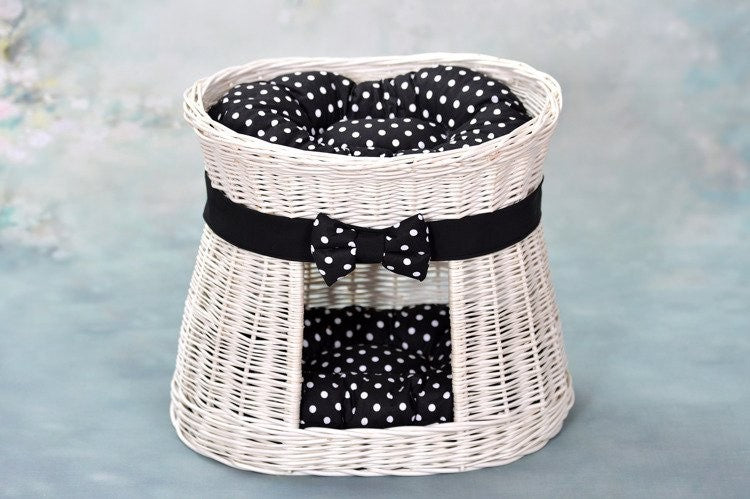 bold whitewashed wicker cat house with two cozy cushions and a commanding front view