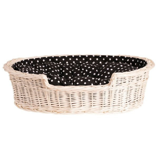 a bold front view of a spacious whitewashed wicker dog bed with a plush cushion