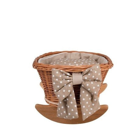 close-up of the mimi cradle's soft beige checkered bedding and white trim