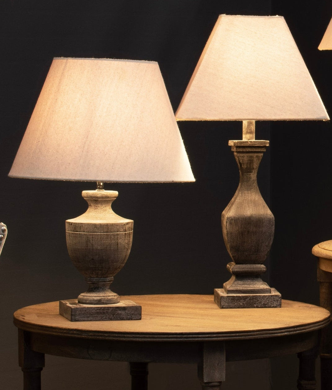 a functional wooden base linen lamp casting a warm glow on a leather bag