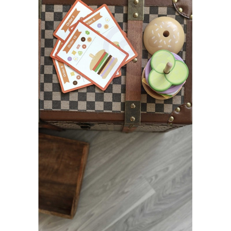 bold close-up of a vibrant wooden burger puzzle with stacked ingredients on a dark background