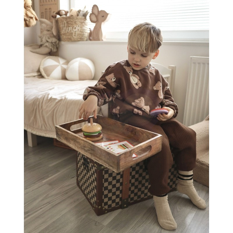 soft-lit wooden burger puzzle pieces arranged neatly on a cozy wooden table