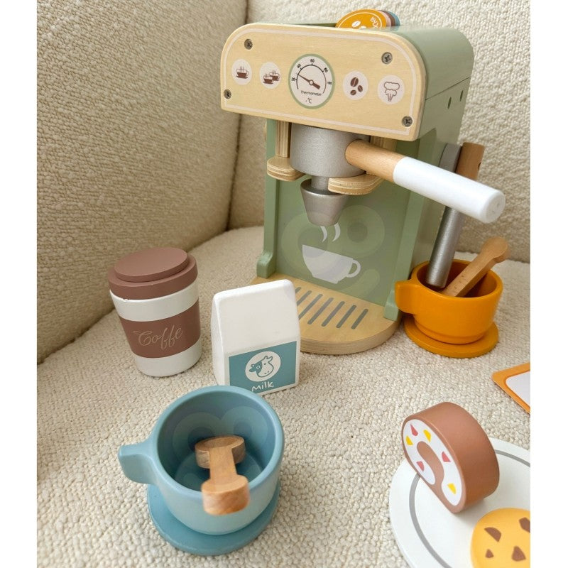 a child's hands arranging the wooden pastries from the woopie green coffee playset on a sunlit table