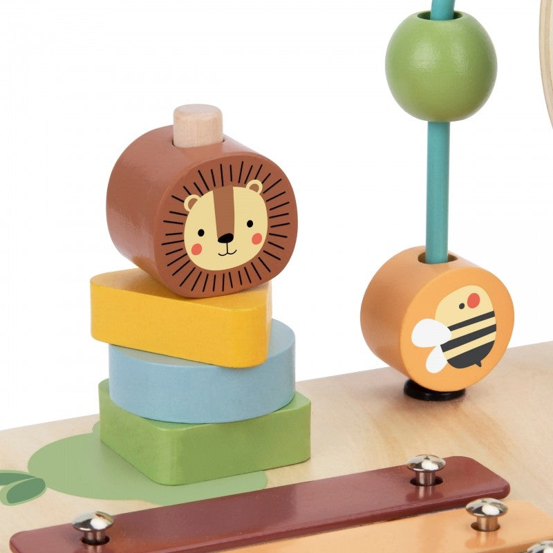 a toddler's hands playing with the colorful ball track on a sustainable wooden activity table