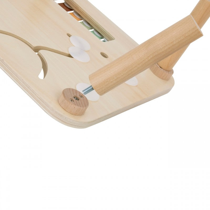 a toddler's hands playing with the sustainable woopie green activity table's gear spinner and ball track