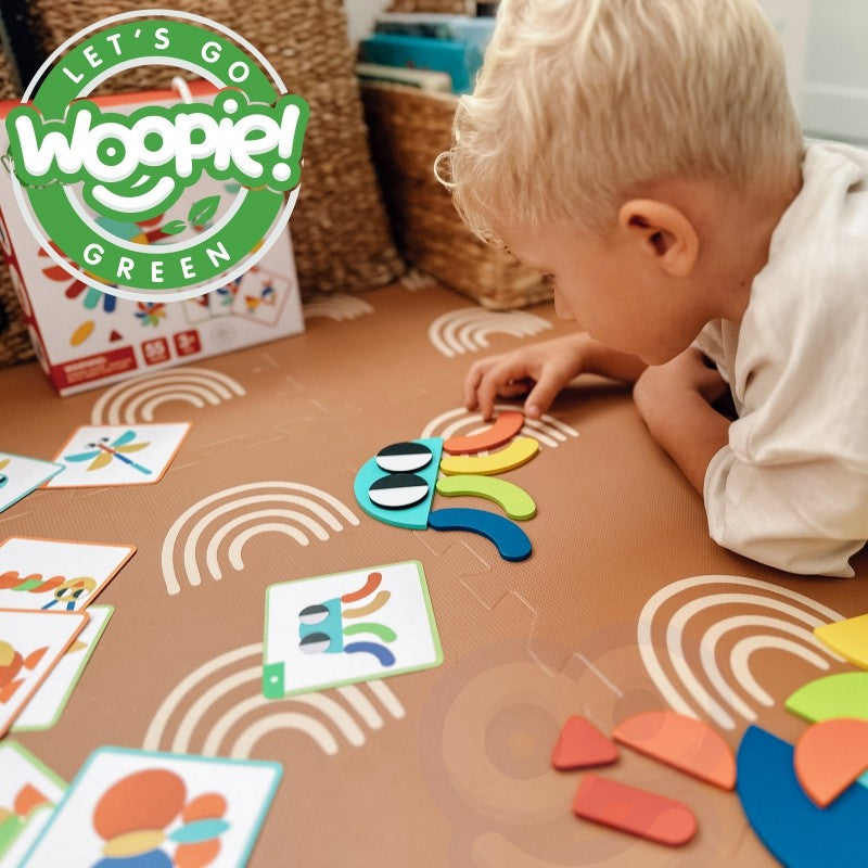 child's hands arranging wooden puzzle pieces into a new creative design on a sunlit table