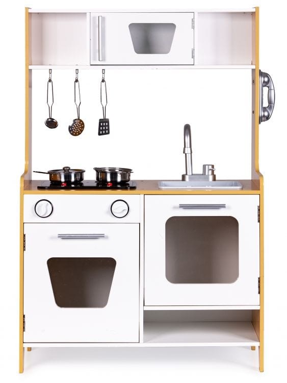 a child's hand turning the dial on the wooden toy kitchen, activating its warm glowing lights